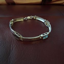 Silver costume jewelry bracelet with colored stones