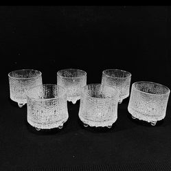 Littala Ultima Thule Liquor Glasses Set of 6 designed by Tappio Wirkkala in 1963 and 2.75” tall. Distinctive textured ice pattern and tri-footed base.