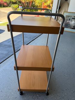 3 shelves table with 4 wheels.