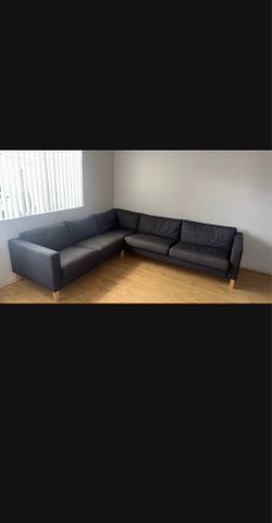 Grey sofa with solid wooden legs
