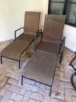 Two foldable patio lounge chairs