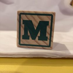 Solid Wood Block With Initials M, P, I , U  and a character a little over one and a half inches wide and tall