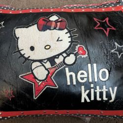 Hello Kitty Pillow. Black Pleather Which Is Wearing, Wrinkling As A Small Hole Starting To The Right Of The Red Embroidered Star. Shiney Rivets Around