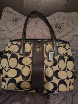 Coach, Color Black With Light Brown, Has A lot Of Space In Side The Purse