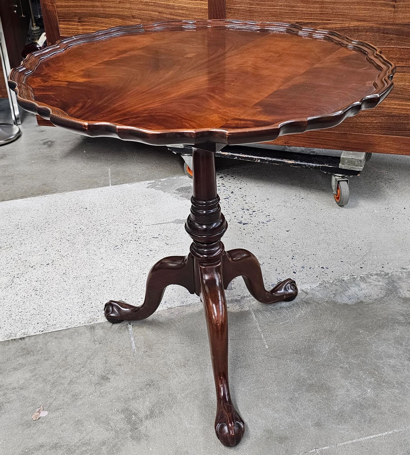 Chippendale-style mahogany birdcage spinning tilt-top tea table with a pie-crust top and ball-and-claw feet.