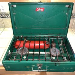The Coleman 413E huge two-burner camp stove good condition.  Come with fuel 3/4 Full