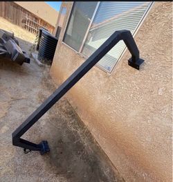 Truck bed roll back bar