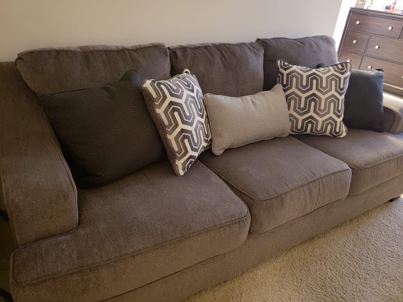 Gray love seat with pillows