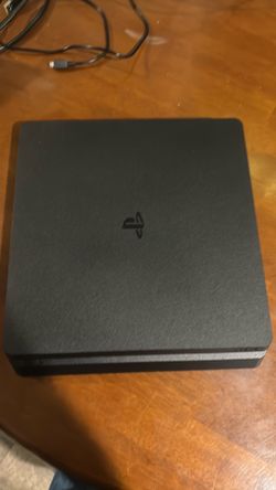 PlayStation 4 with controller and game