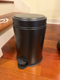 2 small black garbage cans