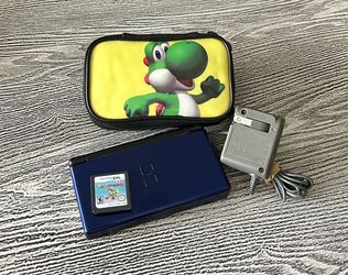Nintendo DS Lite in excellent condition with Yoshi game & case, and OEM Nintendo charger. $65
