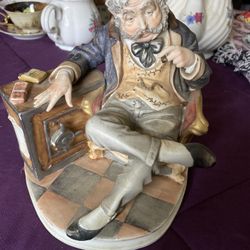 Porcelain smoking banker figure 