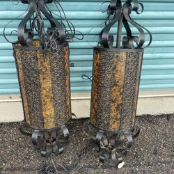 vintage Spanish revival hanging swag lamps, wrought iron and amber plastic lantern-style fixtures 