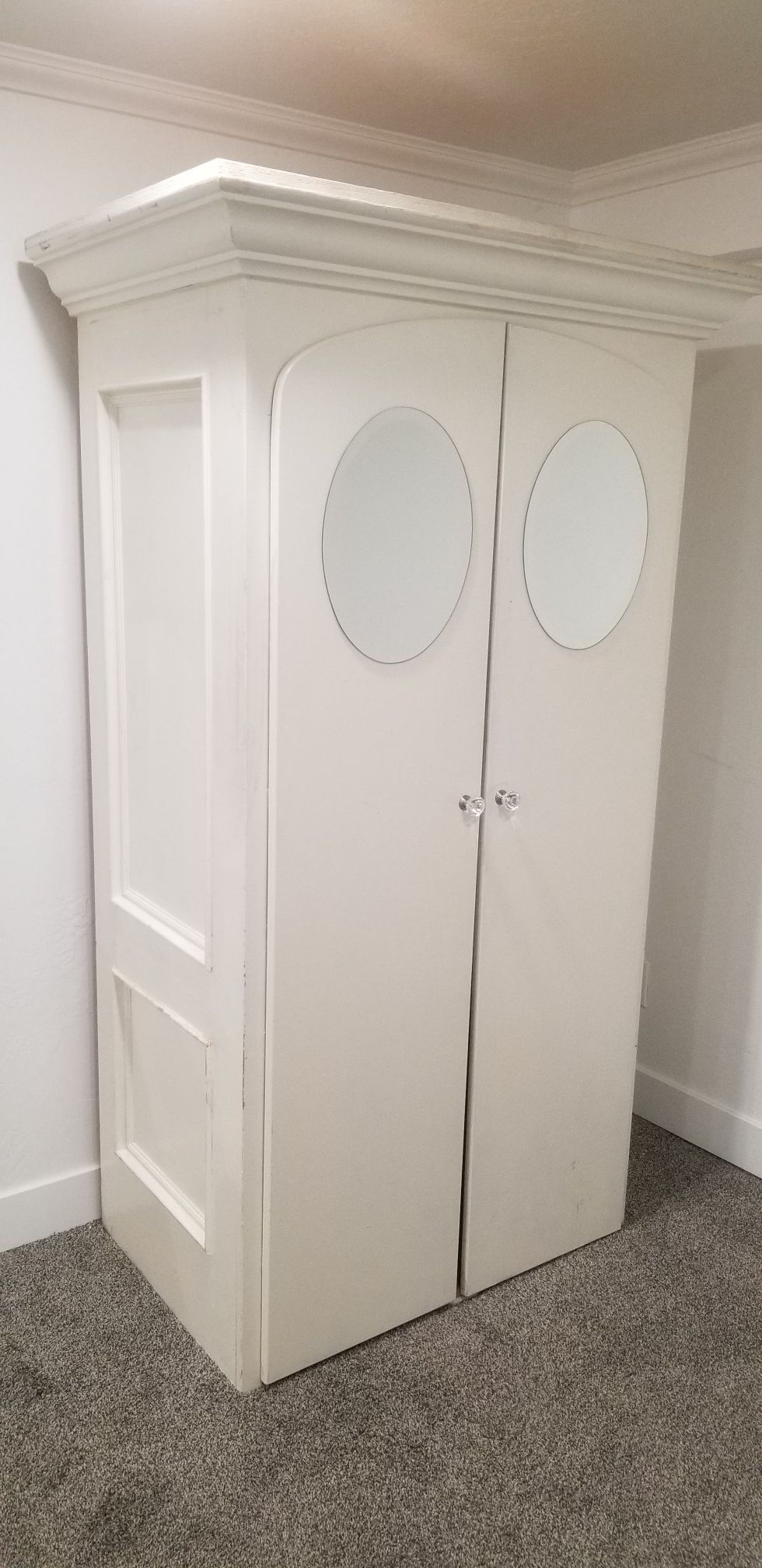Armoire with oval mirrors