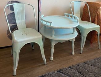 Two blue metal chairs and end table