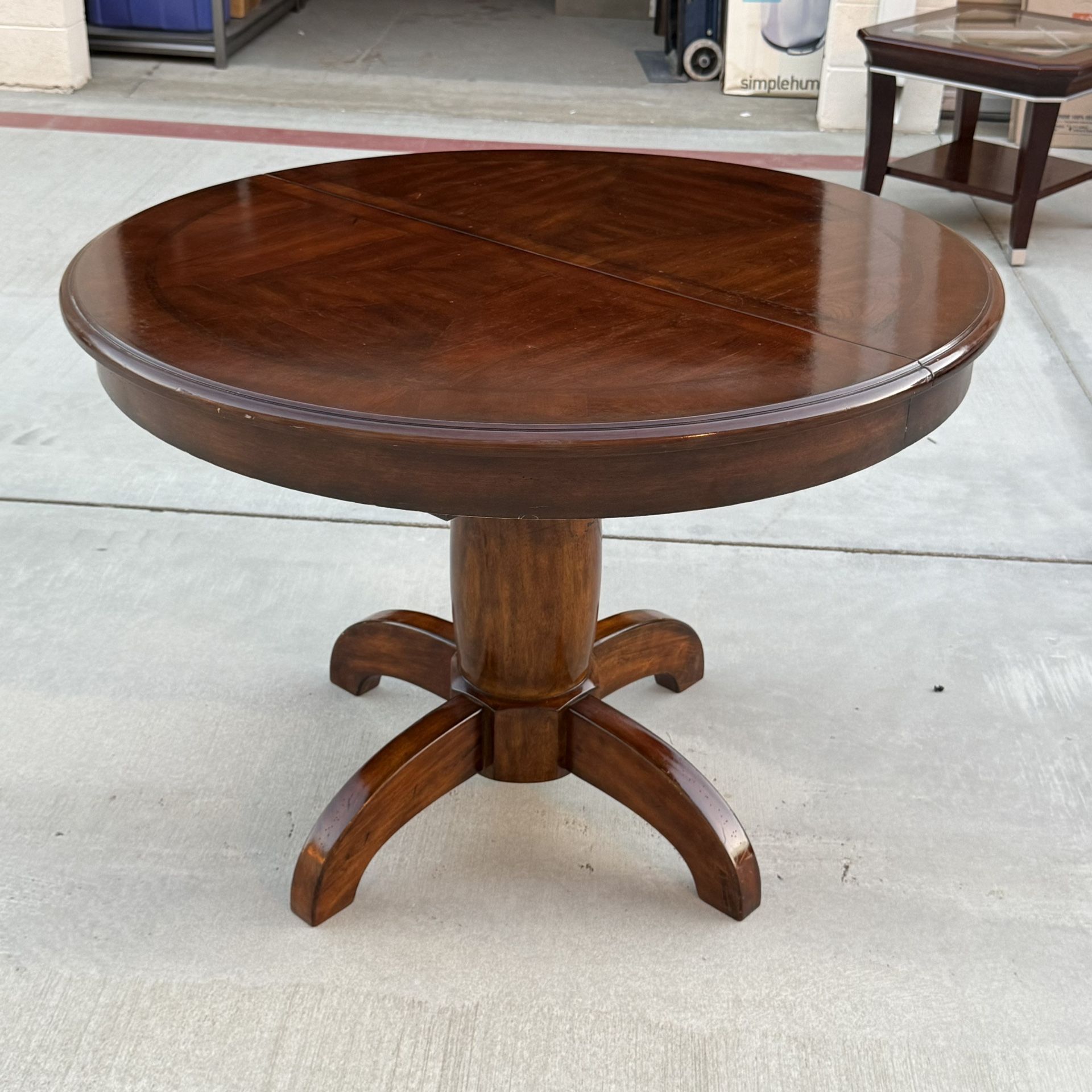 Expandable Round Pedestal Dining Table with Hidden Leaf