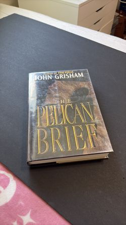 The Pelican Brief by John Grisham .  Hard cover , used good condition .