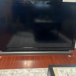 Vizio 55 inch TV and black table for TV power bar Send Some Power Bar