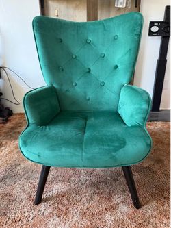 Green mid-century tufted wingback chair