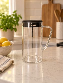 Clear glass pitcher with a black lid