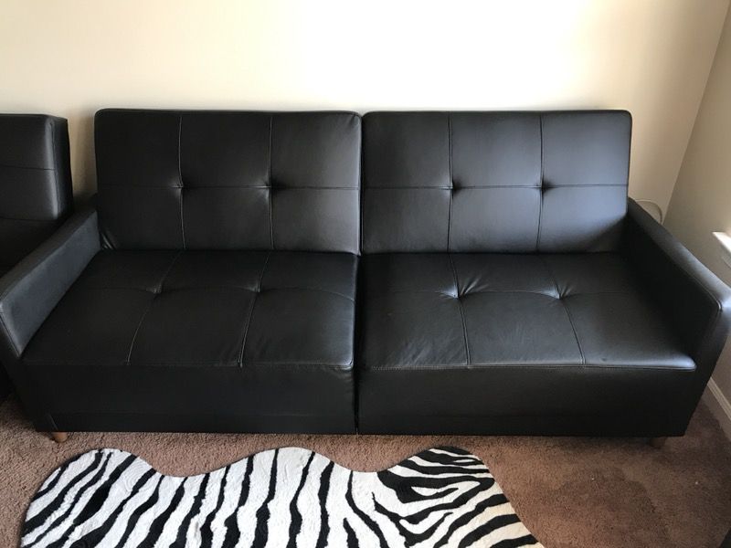 Like new tufted black faux leather sofa couch futon