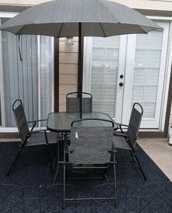 Patio table with chairs and umbrella