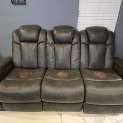 Ashley’s Furniture Synthetic Leather Reclining Couch ( Used). Dark Gray Full Size.