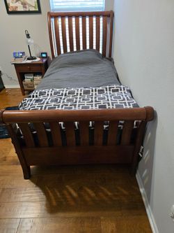 Twin bed, sleigh bed style.