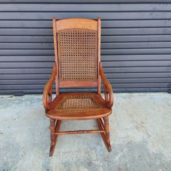 Antique Lincoln Rocker with Cane Seat and Back.