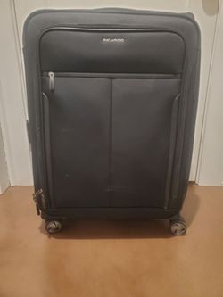 Like new Ricardo medium black rolling suitcase telescopic handle