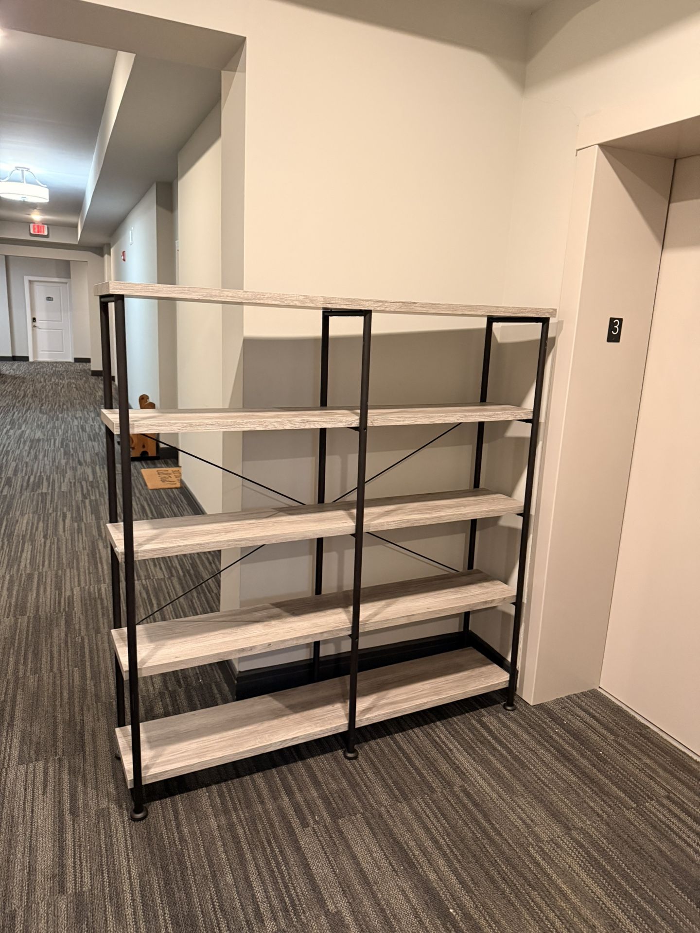 industrial-style, five-tier bookshelf with a light wood-grain finish and black metal frame.