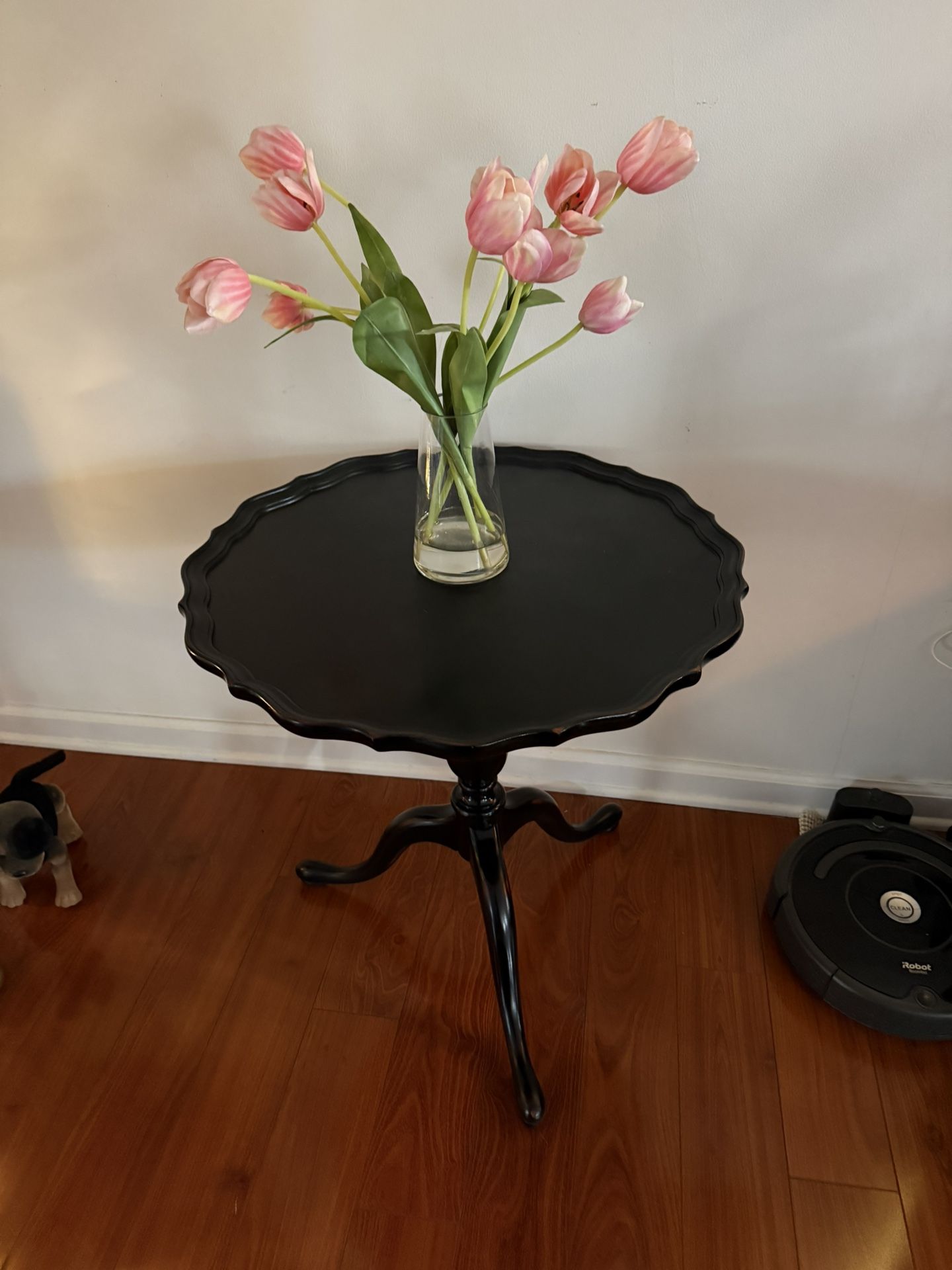 For sale is a sturdy, solid wood mahogany pie crust table. It measures 24 inches by 24 inches and stands 26 inches tall.