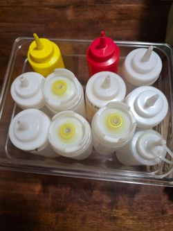 11 assorted plastic refill bottles gor ketchup/mustard/mayo/bbq sauce/chile/ sour cream/butter