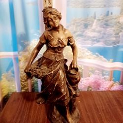 Elegant figurine of a French lady in flowing dress.