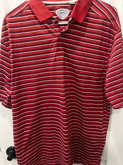 This is a red and white striped Callaway Golf shirt featuring the signature heat-seal logo label on the inner neckline.