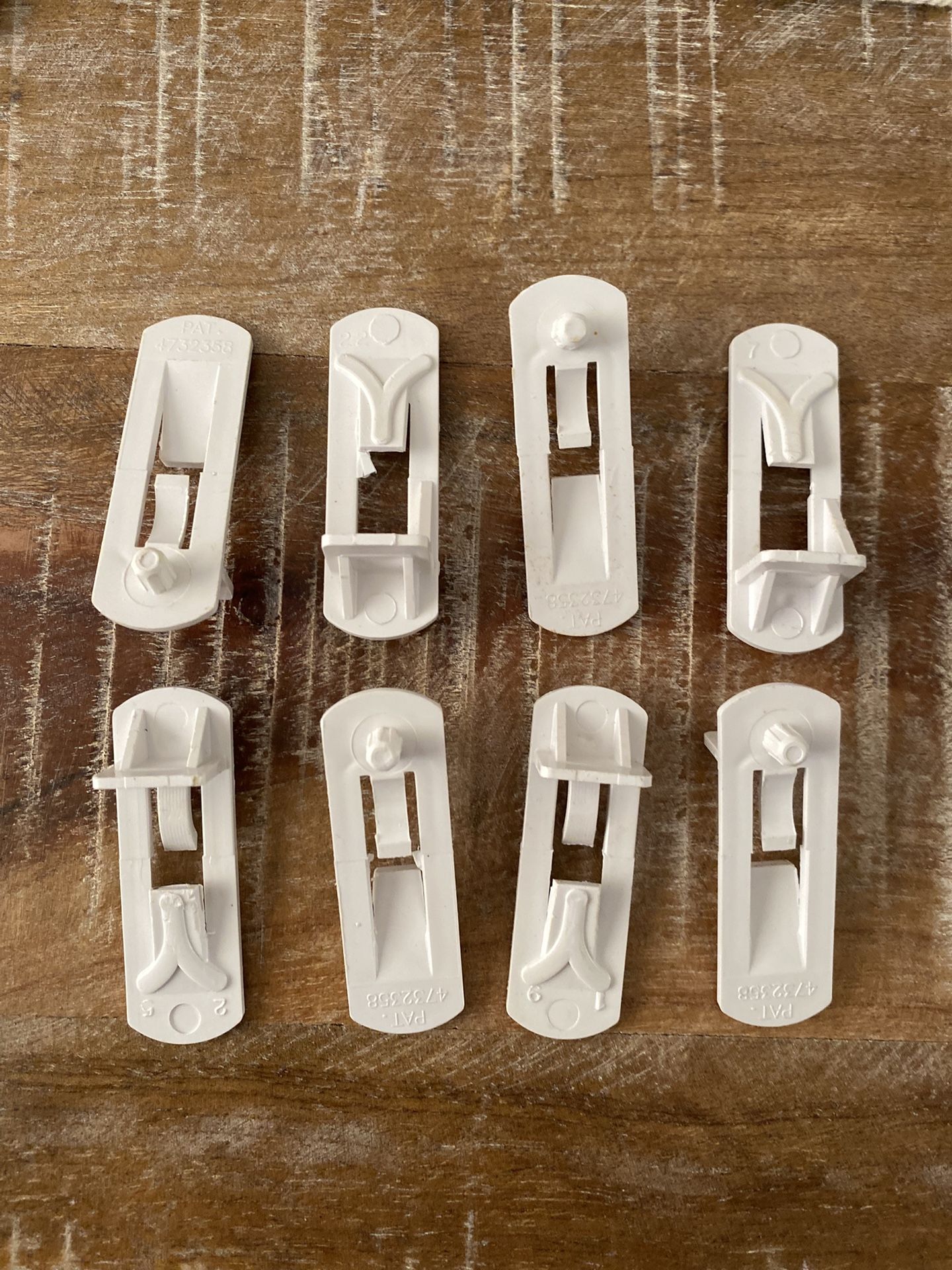 For sale set of 8 new plastic locking shelf pins or cabo net shelf clips.