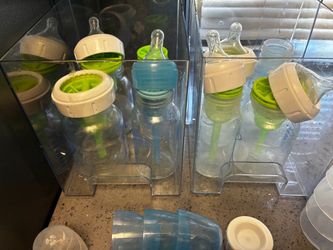8 plastic and glass bottles with covers