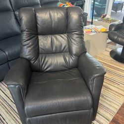 Black Leather Chair That Rocks, Swivels, And Fully Reclines