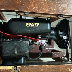 Antique sewing machine with cabinet