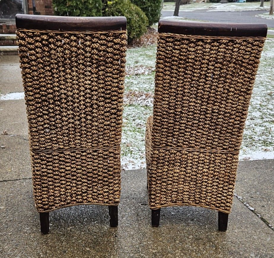 Two Solid wooden chairs with Wicker material seats and backs all in Excellent condition.