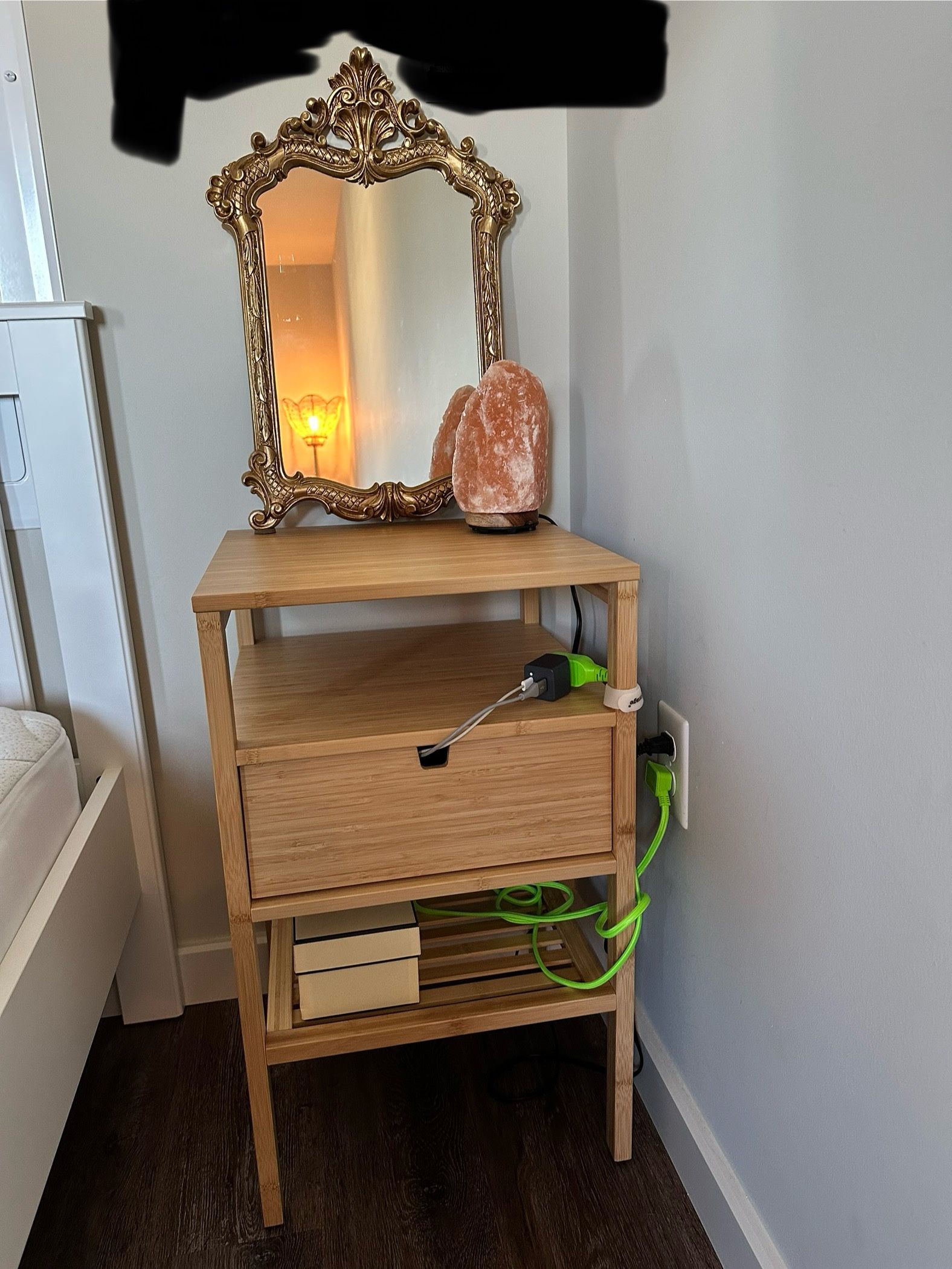 wooden nightstand and gold mirror