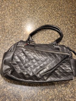 Purse black rectangle diagonall quilted pattern on front apprx 8x14"snowflake logo on metal emblem