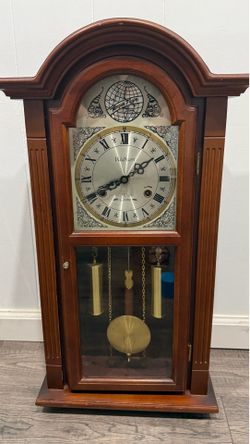 Wooden Mantel Wall Clock in Warm Brown with Brass Accents. wall clock offering classic style and reliable timekeeping. Rich brown wooden case pairs wi