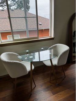 Glass round table with cream fuzzy chairs