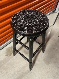 A Pair of black barstools With White Design