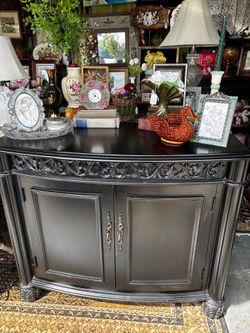 Vintage style black ornate cabinet with gold hardware, inside shelving