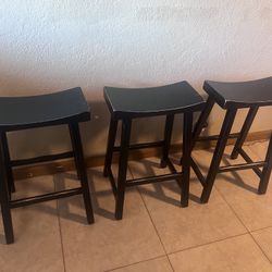 3 black sturdy wooden stools 