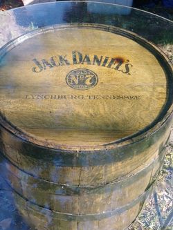 Jack Daniels table and two wrought iron bar stools