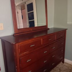 Dresser. Nightstand in a mirror.   