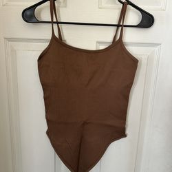 Three bodysuits in brown, bone, and white, with tummy control